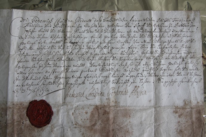 Ein handgeschriebener Brief, der Alterserscheinungen aufweist und mit einem roten Wachssiegel versehen ist. Archiv für Alltagskultur.
